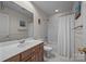 Well-lit bathroom featuring a vanity, toilet, and shower with white tile and neutral wall color at 16028 Cranleigh Dr, Huntersville, NC 28078