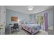 Cozy bedroom with a patchwork quilt bed, a desk, and natural light streaming through the window at 16028 Cranleigh Dr, Huntersville, NC 28078