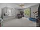 Spacious bedroom featuring a daybed, recliner, shelving, and a trampoline at 16028 Cranleigh Dr, Huntersville, NC 28078