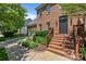 Brick home with manicured front yard, inviting brick staircase and craftsman style front door at 16028 Cranleigh Dr, Huntersville, NC 28078
