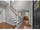Bright foyer featuring wood floors, an open staircase and inviting entrance to the living spaces at 16028 Cranleigh Dr, Huntersville, NC 28078