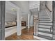 Bright foyer featuring wood floors, an open staircase and inviting entrance to the living spaces at 16028 Cranleigh Dr, Huntersville, NC 28078