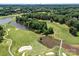 Scenic aerial view of a golf course with lush greens, ponds, sand traps and mature trees at 16028 Cranleigh Dr, Huntersville, NC 28078