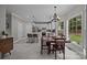 Bright kitchen featuring white cabinets, stainless steel appliances, island with seating, and an adjacent dining area with large windows at 16028 Cranleigh Dr, Huntersville, NC 28078