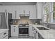 Close-up of a well-equipped kitchen with stainless steel appliances, quartz countertops, and stylish backsplash at 16028 Cranleigh Dr, Huntersville, NC 28078