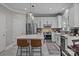 Stylish kitchen with white cabinets, stainless steel appliances, a center island with seating, and decorative pendant lighting at 16028 Cranleigh Dr, Huntersville, NC 28078