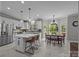 Bright kitchen with island, modern appliances, a breakfast nook and tiled floor at 16028 Cranleigh Dr, Huntersville, NC 28078