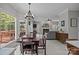 Open-concept living and dining area with a fireplace, large windows, and access to an outdoor deck at 16028 Cranleigh Dr, Huntersville, NC 28078