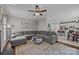 Spacious living room featuring a large sectional sofa, fireplace, and an open layout to the kitchen and dining areas at 16028 Cranleigh Dr, Huntersville, NC 28078