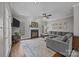 Cozy living room with a fireplace, a large sectional sofa, and a TV, creating a comfortable and inviting atmosphere at 16028 Cranleigh Dr, Huntersville, NC 28078