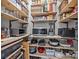 Organized pantry with wooden shelves filled with a variety of food items, kitchen appliances, and storage baskets at 16028 Cranleigh Dr, Huntersville, NC 28078