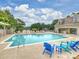 Community pool area with lounge chairs, umbrellas, and a covered pavilion at 16308 Woolwine Rd, Charlotte, NC 28278