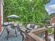 Relaxing outdoor deck space featuring a comfortable seating area surrounded by lush greenery at 16308 Woolwine Rd, Charlotte, NC 28278