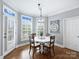 Cozy dining area with natural light, decorative lighting and a modern farmhouse clock at 16308 Woolwine Rd, Charlotte, NC 28278
