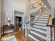 Bright foyer with staircase, hardwood floors, and views into other rooms at 16308 Woolwine Rd, Charlotte, NC 28278