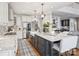 Open concept kitchen with a center island that offers seating, stainless steel appliances, and white cabinetry at 16308 Woolwine Rd, Charlotte, NC 28278