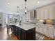 Open concept kitchen featuring stainless appliances, a breakfast bar, and seamless flow into the dining areas at 16308 Woolwine Rd, Charlotte, NC 28278
