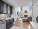 Stylish wet bar with cabinets open to a bright living room with fireplace feature at 16308 Woolwine Rd, Charlotte, NC 28278
