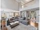 Spacious living room with second-floor balcony, offering a view of the eat-in kitchen and bright front entrance at 16308 Woolwine Rd, Charlotte, NC 28278