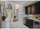 Open floor plan with wet bar and a view of the bright living room with fireplace at 16308 Woolwine Rd, Charlotte, NC 28278