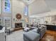 Bright open-concept living room featuring a fireplace, high ceilings, and seamless flow into the dining and kitchen areas at 16308 Woolwine Rd, Charlotte, NC 28278