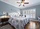 Comfortable bedroom with a ceiling fan, natural light from shuttered windows, and hardwood floors at 16308 Woolwine Rd, Charlotte, NC 28278