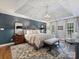 Spacious main bedroom boasts tray ceilings, a cozy sitting area, and hardwood floors at 16308 Woolwine Rd, Charlotte, NC 28278