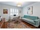 Well-lit home office featuring a comfortable sofa, desk, and colorful rug at 16308 Woolwine Rd, Charlotte, NC 28278