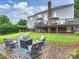 Inviting outdoor patio with comfortable seating around a fire pit, perfect for gatherings at 16308 Woolwine Rd, Charlotte, NC 28278