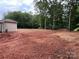 Large lot with a partially cleared backyard surrounded by mature trees at 1987 Robert Rufty Ln, Catawba, NC 28609