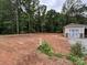 Spacious and partially cleared backyard next to a detached garage and mature trees at 1987 Robert Rufty Ln, Catawba, NC 28609