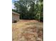Large backyard featuring tilled dirt and straw covering for growing new grass, backing up to woods at 1987 Robert Rufty Ln, Catawba, NC 28609