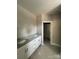 A bathroom shows a dual sink vanity with granite countertop and open closet at 1987 Robert Rufty Ln, Catawba, NC 28609