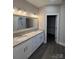 Bathroom featuring a double vanity, granite countertop, modern lighting, and luxury vinyl plank flooring at 1987 Robert Rufty Ln, Catawba, NC 28609