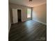 Neutral bedroom with wood-look flooring, white trim, and window view at 1987 Robert Rufty Ln, Catawba, NC 28609