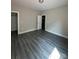 Bright bedroom featuring flooring, door to another room and closet at 1987 Robert Rufty Ln, Catawba, NC 28609