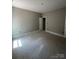 A bedroom boasts a door leading to another room and natural light for the plywood flooring at 1987 Robert Rufty Ln, Catawba, NC 28609