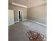 A bedroom offers a door leading to another room and natural light for the plywood flooring at 1987 Robert Rufty Ln, Catawba, NC 28609
