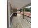 Covered porch with wood railings, perfect for relaxation and enjoying the view, newly constructed at 1987 Robert Rufty Ln, Catawba, NC 28609
