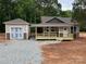 Charming single-Gathering home featuring a covered porch, neutral siding, and a detached garage in a wooded neighborhood at 1987 Robert Rufty Ln, Catawba, NC 28609