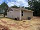 Exterior view of the house shows beige siding and a large air conditioning unit on the side at 1987 Robert Rufty Ln, Catawba, NC 28609