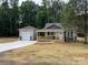 Charming home with a covered porch and a detached garage on a neatly mulched lawn at 1987 Robert Rufty Ln, Catawba, NC 28609