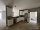 Unfinished kitchen featuring white cabinets, granite countertop, and a view to the bathroom, awaiting appliances at 1987 Robert Rufty Ln, Catawba, NC 28609