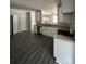 Corner view of open kitchen with white cabinets, stainless appliances and granite countertops at 1987 Robert Rufty Ln, Catawba, NC 28609