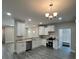 Bright kitchen featuring white cabinets, granite countertops, stainless steel appliances, and stylish lighting fixtures at 1987 Robert Rufty Ln, Catawba, NC 28609