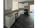 Spacious kitchen featuring white cabinets, granite counters, stainless appliances, and modern gray flooring at 1987 Robert Rufty Ln, Catawba, NC 28609