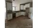 Unfinished kitchen featuring white cabinets, granite countertop, and a view to the living room, awaiting appliances at 1987 Robert Rufty Ln, Catawba, NC 28609