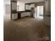 Unfinished kitchen featuring white cabinets, granite countertop, and a view to the living room, awaiting appliances at 1987 Robert Rufty Ln, Catawba, NC 28609