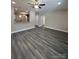 Open-concept living room features modern gray wood flooring and a ceiling fan at 1987 Robert Rufty Ln, Catawba, NC 28609