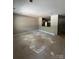 Unfinished room featuring smooth walls, recessed lighting, and a kitchen view, awaiting personalized finishing touches at 1987 Robert Rufty Ln, Catawba, NC 28609